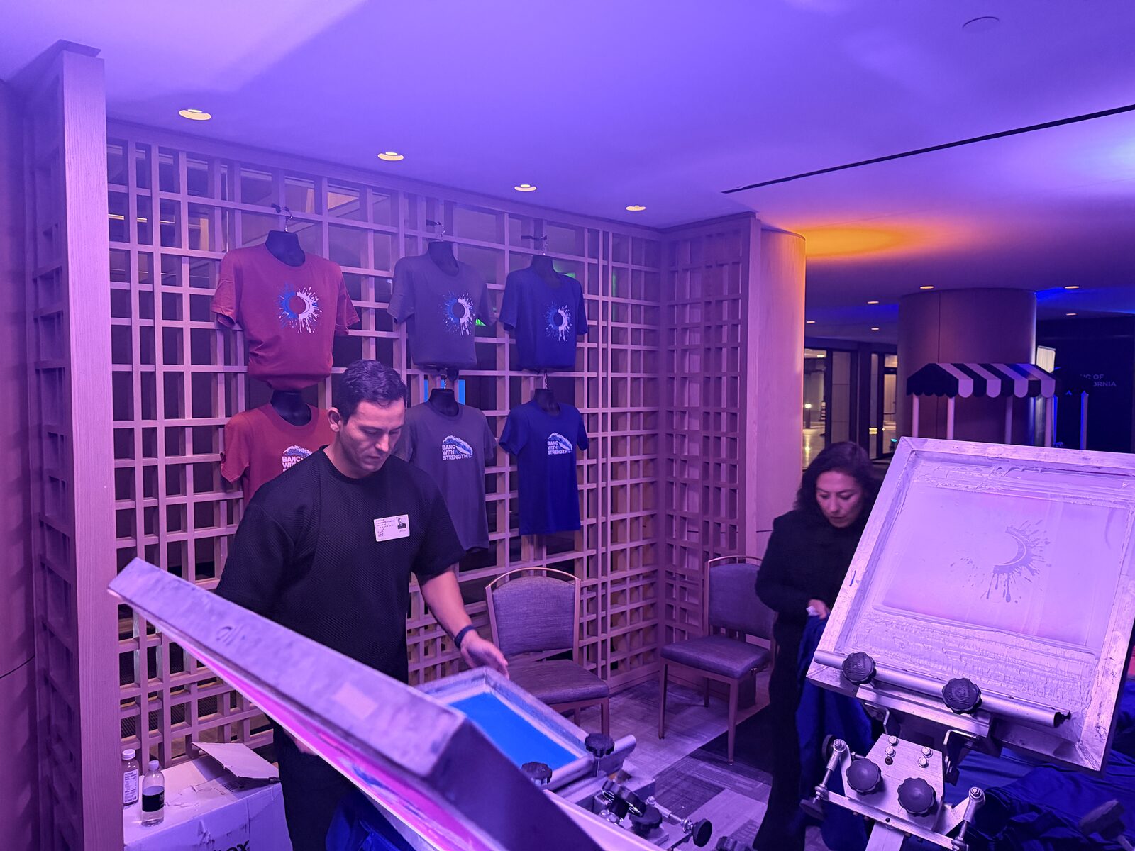 Wall of design options at a live shirt bar event