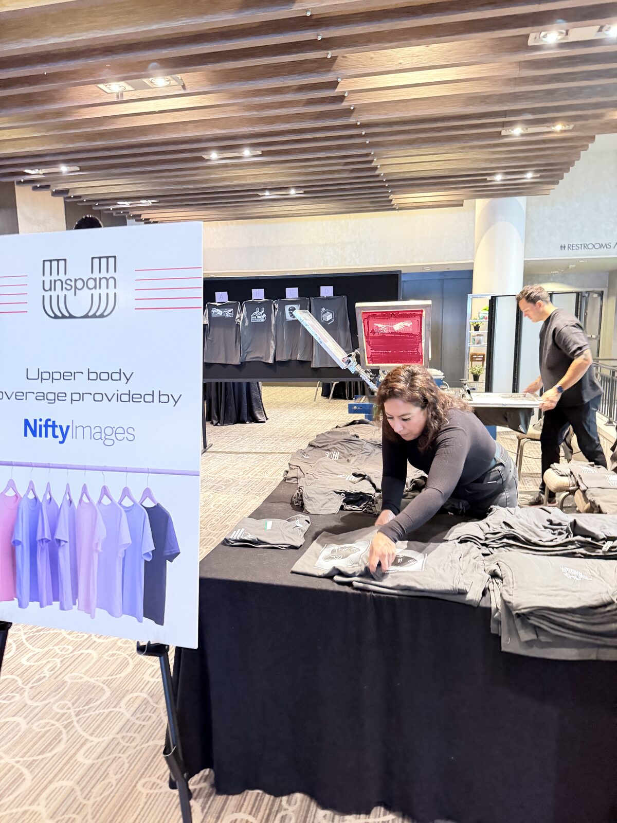 Conference merch table with custom shirts
