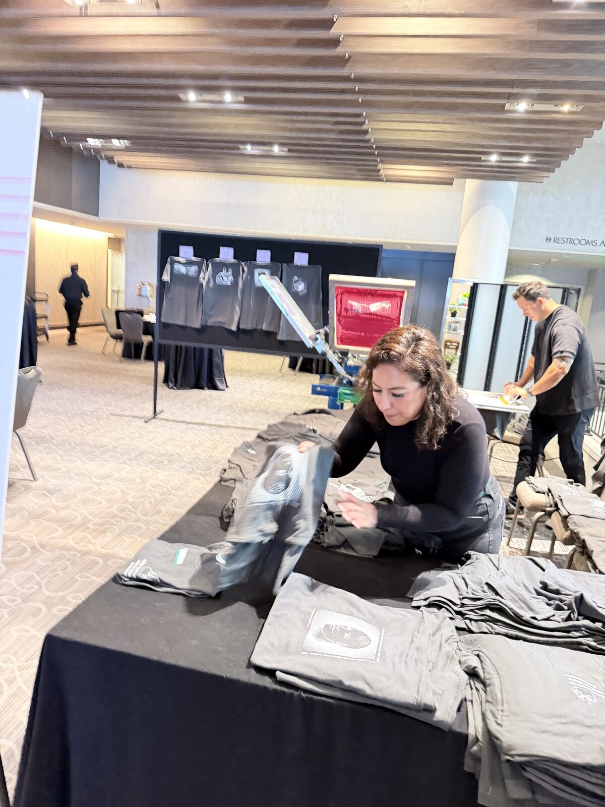 Folding fresh printed shirts for guest handoff